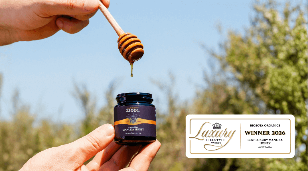 Best luxury Manuka honey being showcased with a honey dipper, highlighting its prestigious award.