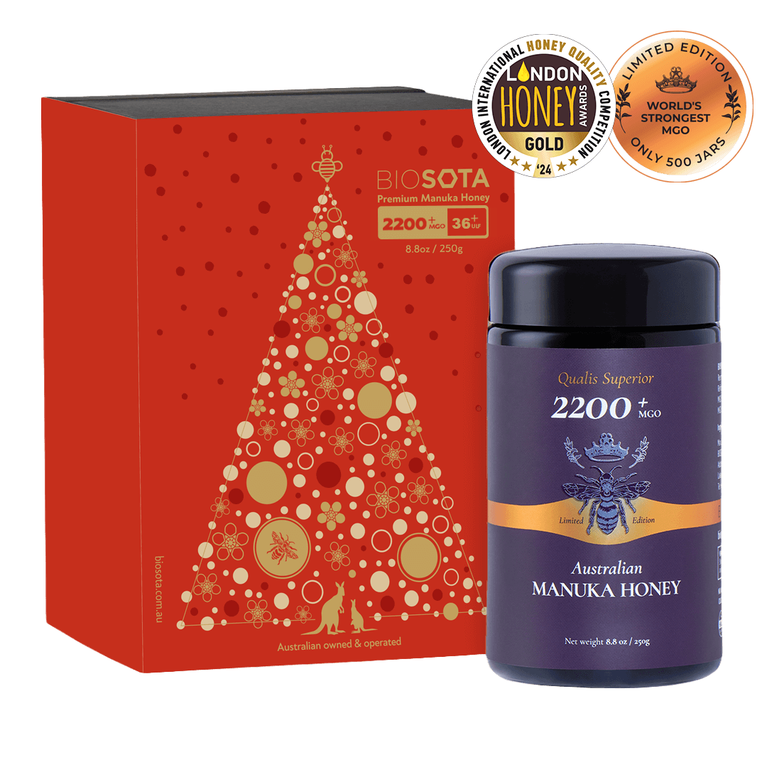 Australian Manuka Honey bottle with red decorative box featuring a Christmas tree design.