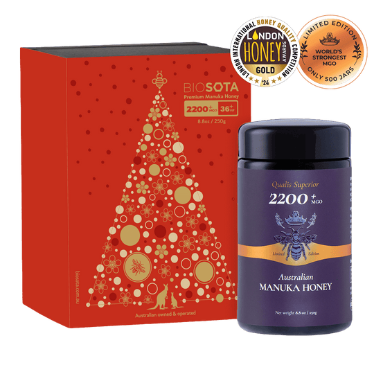 Australian Manuka Honey bottle with red decorative box featuring a Christmas tree design.