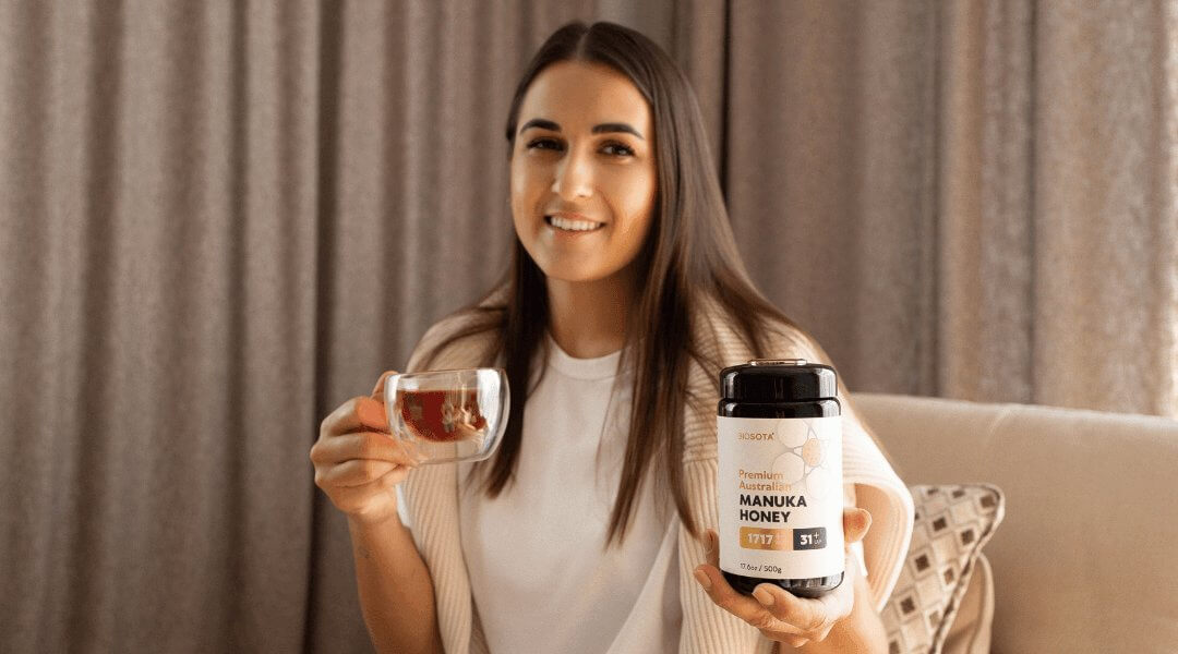 Woman showing how to use Manuka honey in a cup of tea